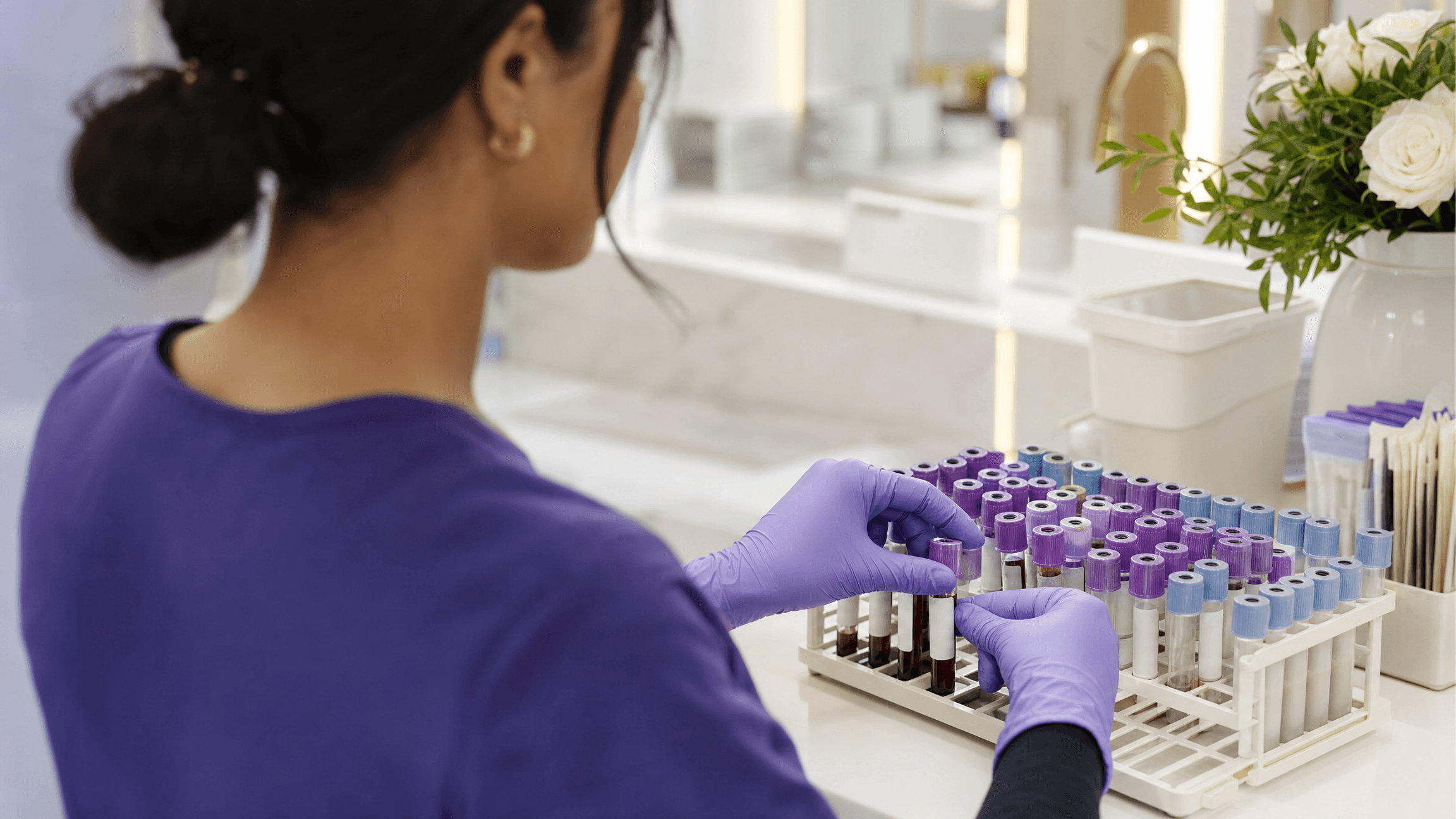 A clinician carefully labeling blood collection tubes for lab work
